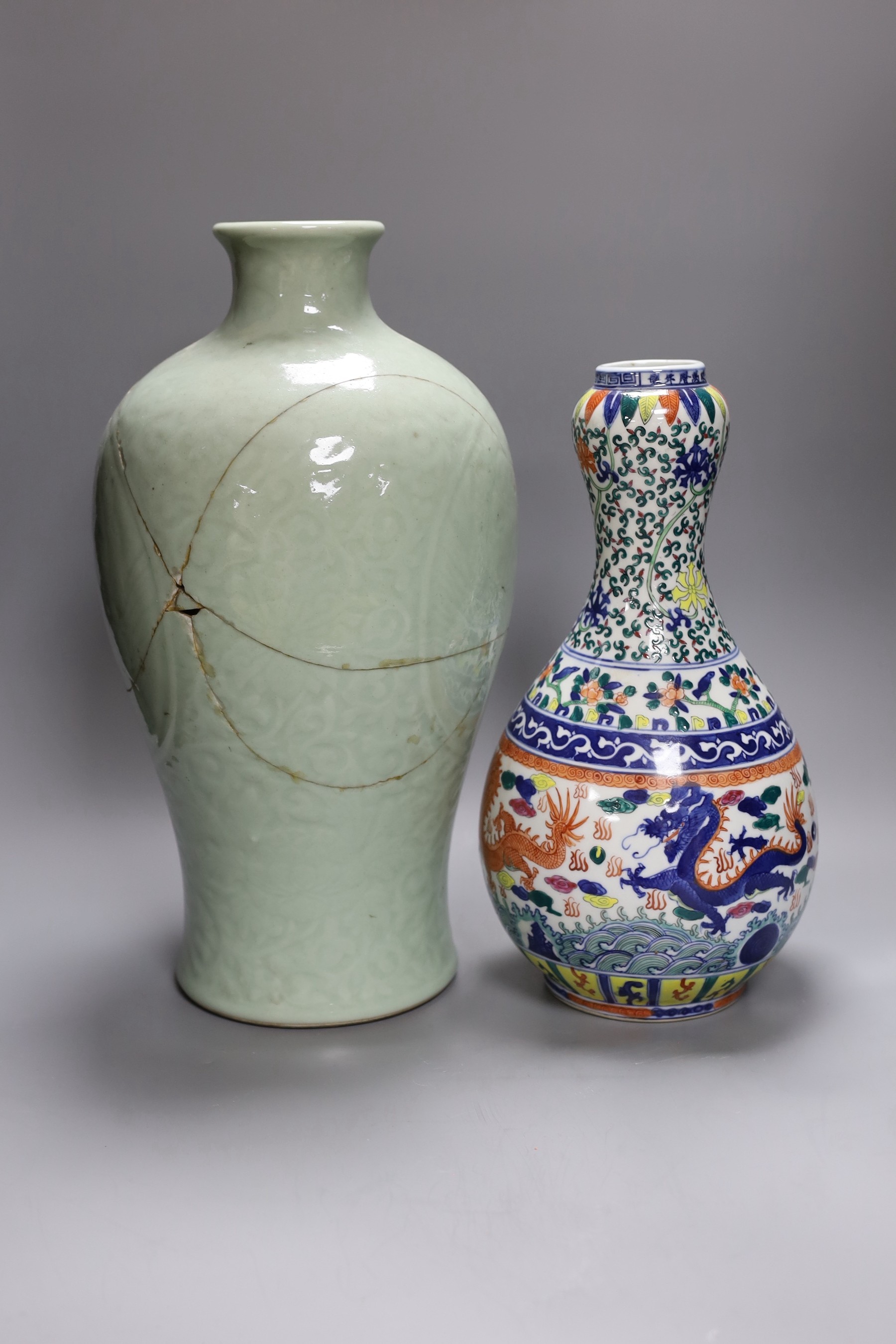A large Chinese slip decoration celadon vase, together with another dragon vase, tallest 40cm